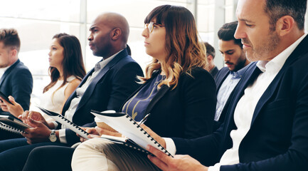 Aufkleber - Interesting content is crucial to keeping an audience engaged. Shot of a group of businesspeople taking down notes while attending a conference.