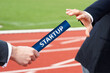Businessmen hand over in Startup baton relay race 