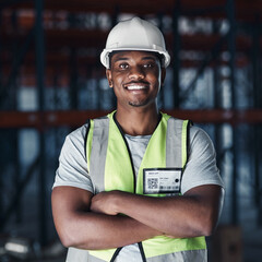 Wall Mural - Your shipment is safe in our warehouse. Shot of a handsome young contractor standing alone in the warehouse with his arms crossed.