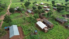 Aerial View To Rural Village In Africa. Mud Huts And Agricultural Land. Local People Living In Small Communities In Tanzania