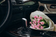 Bouquet of pink tulips lying in car
