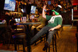 © AvokadoStudio - cheerful ginger man in leprechaun hat for st. patrick's day orders two beers