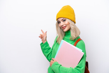 Wall Mural - Young Russian student woman isolated on white background pointing back