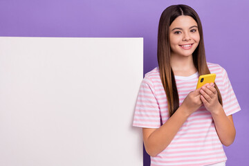 Sticker - Portrait of cheerful nice person hold use telephone empty space offer promo placard isolated on purple color background