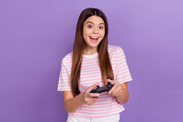 Sticker - Photo of impressed funny girl dressed striped t-shirt enjoying playstation game isolated purple color background