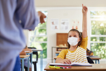 Sticker - Smart student with covid face mask asking teacher question about corona virus pandemic in a classroom or elementary school. Little girl child raising hand to answer healthcare related topic in class