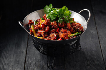 Wall Mural - Chinese fried chicken with chili pepper in a wok pan