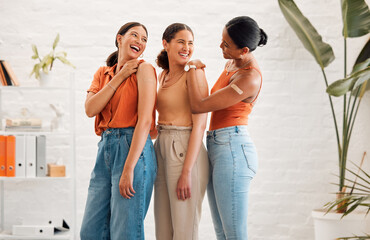 Female friends after receiving covid vaccine, happy and smiling, approving the immunity injection showing plaster arms. Diverse women recommend booster jab for protection from corona virus.