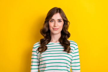 Sticker - Photo of attractive office worker lady curly brown hair enjoy her job wearing stylish striped white pullover isolated on yellow color background