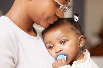 Poster - Shes getting tired now. Shot of an adorable baby girl sucking a dummy while being held by her mother at home.