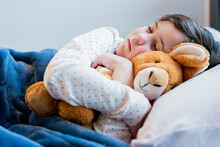 Adorable Girl Sleeping With Plush Toy