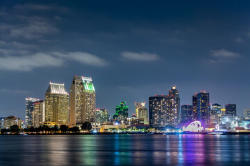 Wall Mural - San Diego skyline at night with water colorful reflections, view from Coronado island, California