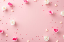 Mother's Day Concept. Top View Photo Of White And Pink Rose Buds Small Hearts And Sprinkles On Isolated Pastel Pink Background With Copyspace In The Middle