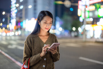 Poster - Woman use of mobile phone in city at night