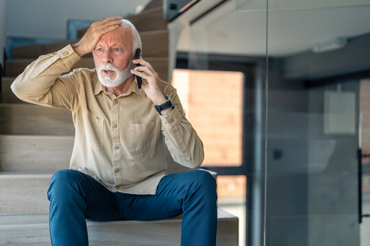 worried senior man with hand on his head hearing bad news over cell phone, looking shocked and frust