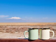 © exithope - Two enameled cups of coffee or tea in the autumn landscape outdoors.Two enamel mugs in the foreground, beautiful view of the snowy mountain erciyes. Copy space for text.