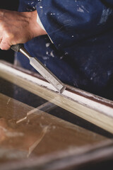 Restoration of old sash windows -  wooden frames are scraped from old patty and paint.