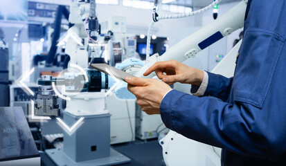 Aufkleber - Engineer uses a digital tablet to control robots in a smart factory. Smart industry 4.0 concept	
