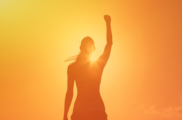 strong fit female woman with fist up to the sky