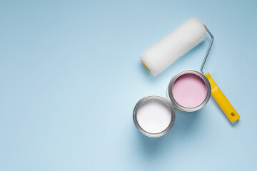 Canvas Print - Cans with different paints and roller on light blue background, flat lay. Space for text