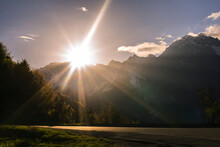 Scenic View Of Sunbeams Over Snowcapped Mountain During Sunrise