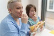© hurricanehank - White woman with short hair eating fries and gyros with her son. Portrait of cheerful female and a cute little boy enjoying their meal in a fast food restaurant