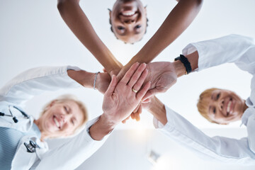 Doctor, group and stack hands in circle for teamwork portrait, happiness or support in hospital for healthcare goal. Doctors, clinic team and huddle for motivation, solidarity or diversity with women