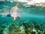 Fototapeta Łazienka - woman snorkeling in clear tropical sea