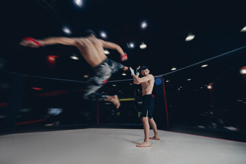 Wall Mural - MMA Boxers fighters in fights without rules in ring octagon, motion blur, dark background