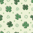 Hand drawn clover leaves seamless pattern on light green background