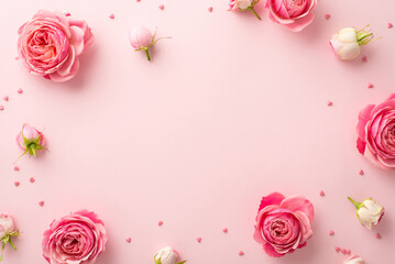 Wall Mural - Women's Day celebration concept. Top view photo of spring flowers pink peony roses and sprinkles on isolated pastel pink background with copyspace in the middle