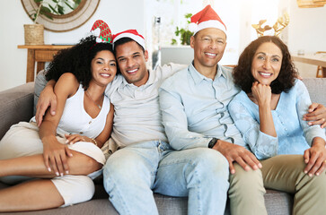 Canvas Print - Christmas, happy family and people on holiday in a home celebrating on vacation and bonding in a house. Portrait, men and women on a couch or sofa in December for celebration together in living room