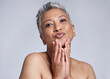 Face, skincare and pout with a mature woman in studio on a gray background to promote natural beauty. Portrait and wellness with a senior female inside to model antiaging treatment or care
