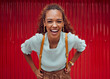 Woman, happy and freedom fashion, smile and outdoor fun on the weekend alone. Portrait of a young female laugh, fashionable and feeling confident while spending her free time on a red background
