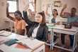 © David L/peopleimages.com - Classroom, students and hands for question, knowledge or education with diversity group, youth and learning development. Hand sign, scholarship information and teenager in school desk for course exam