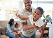© David L/peopleimages.com - Dad, boy and toy plane in living room for game, fun or bonding while happy together. Father, son and play airplane toys with smile at house with love, happiness or family home lounge in Orlando