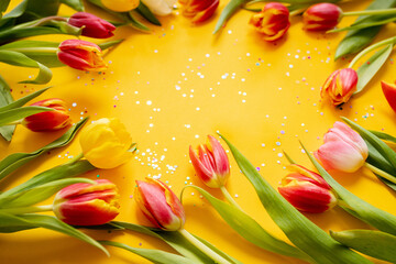 Wall Mural - beautiful frame floral layout with tulips on a bright yellow background. top view. copy space. flat lay