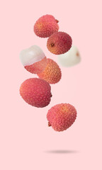 Wall Mural - Isolated exotic fruit. Lychee fruits falling down with clipping path as package design element. Full depth of field. Food levitation concept. Fresh fruits.