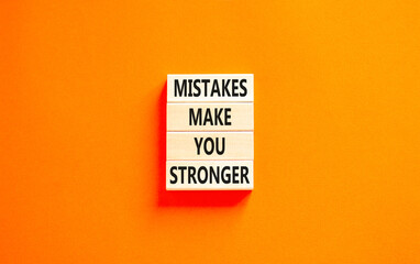 Wall Mural - Mistake make stronger symbol. Concept words Mistakes make you stronger on wooden blocks. Beautiful orange table orange background. Business mistake make stronger concept. Copy space.