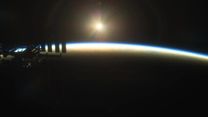 Wall Mural - international space station iss floating in orbit above planet earth in outer space. sunrise or suns