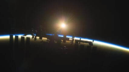 Wall Mural - international space station iss floating in orbit above planet earth in outer space. sunrise or suns