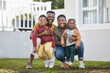 © Siphosethu F/peopleimages.com - Parenting these incredible kids has been one of our greatest achievements. Shot of a couple standing in front of a house with their two children.