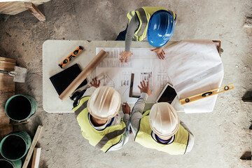 Poster - Architect, construction and blueprint with an engineer and designer team working on a building site from above. Meeting, planning and architecture with a design group in collaboration on a project