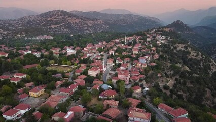 Wall Mural - The aerial video of Ormana village in the mountains of Turkey is undeniably charming, with its quaint houses and picturesque streets nestled among the rolling hills.