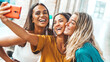 © Davide Angelini - Happy female friends taking selfie picture with smart mobile phone device outside - Three young women having fun hanging out in city street - Teenagers addicted to social media - Youth lifestyle