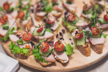 Office party catering, table with variety of different food snacks on a workplace, sandwiches, croissants and appetizers on a party event or celebration, coffee break for colleagues and employees