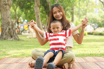 Mother and baby playing in the park happily.