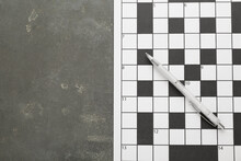 Blank Crossword And Pencil On Grey Table, Top View. Space For Text