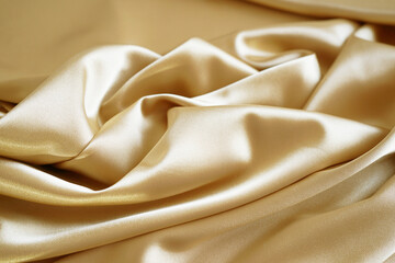 Wall Mural - Silk satin. Golden beige color. Luxury background for design. Creases in fabric. Silky, shiny, smooth, soft.
