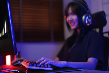 Female cyber hacker gamer in headphone serious face to playing games or hacking programming system